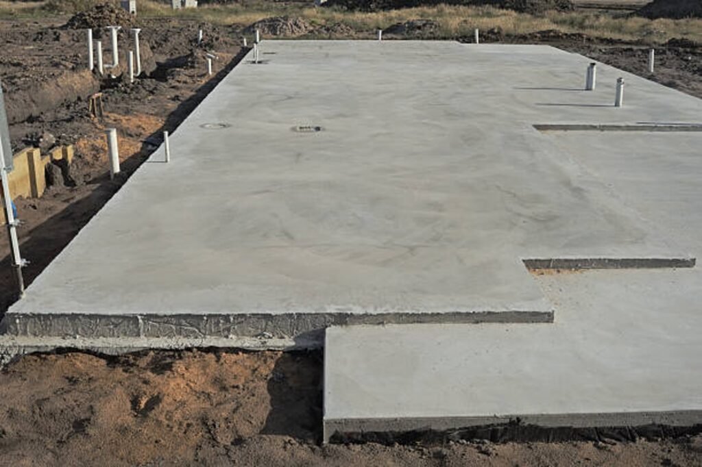 Newly poured concrete slab foundation with smooth finish and structural layout in Medina, OH